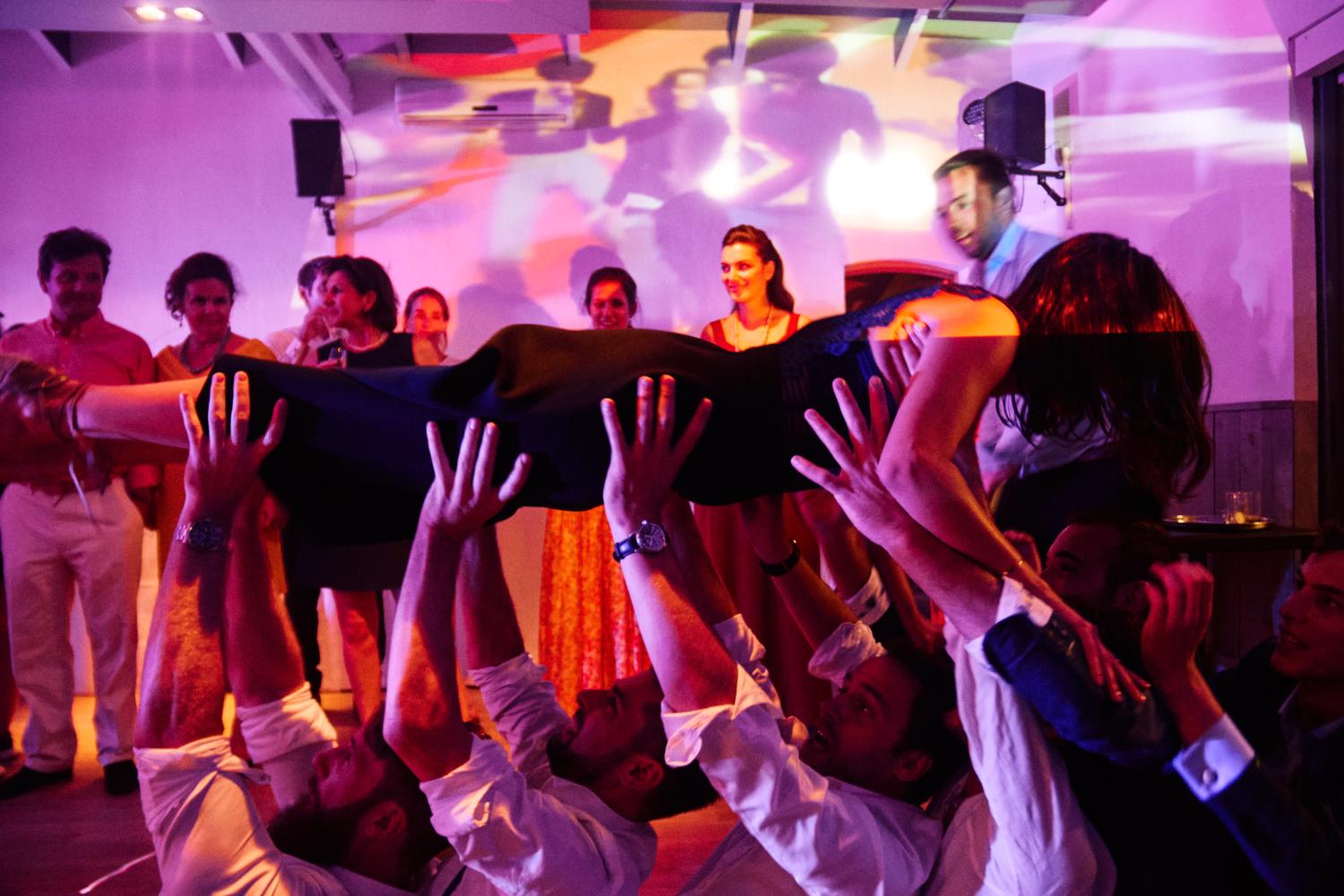 A wedding guest crowdsurfing on the dancefloor at Chateau Val Joanis