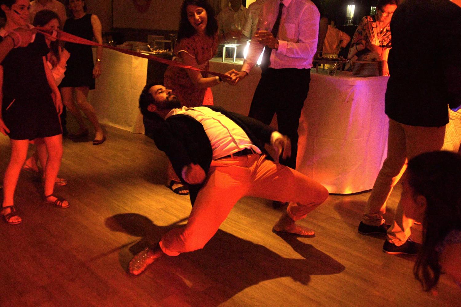 Man plays limbo at wedding