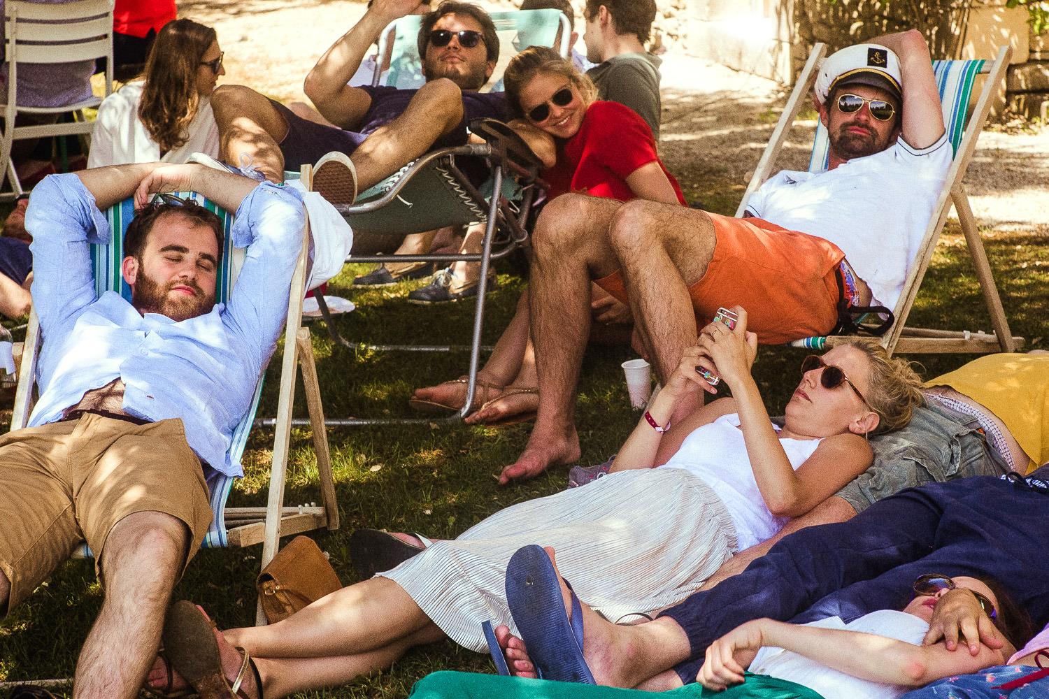 Guests sleep and relax at a French pool party