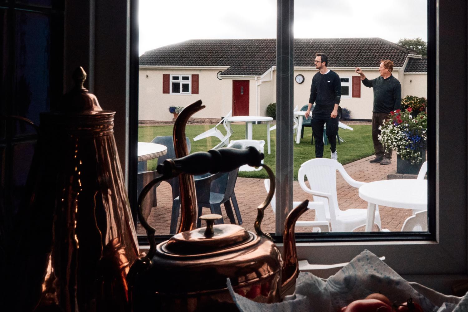 A father and son prepare a garden for a wedding reception