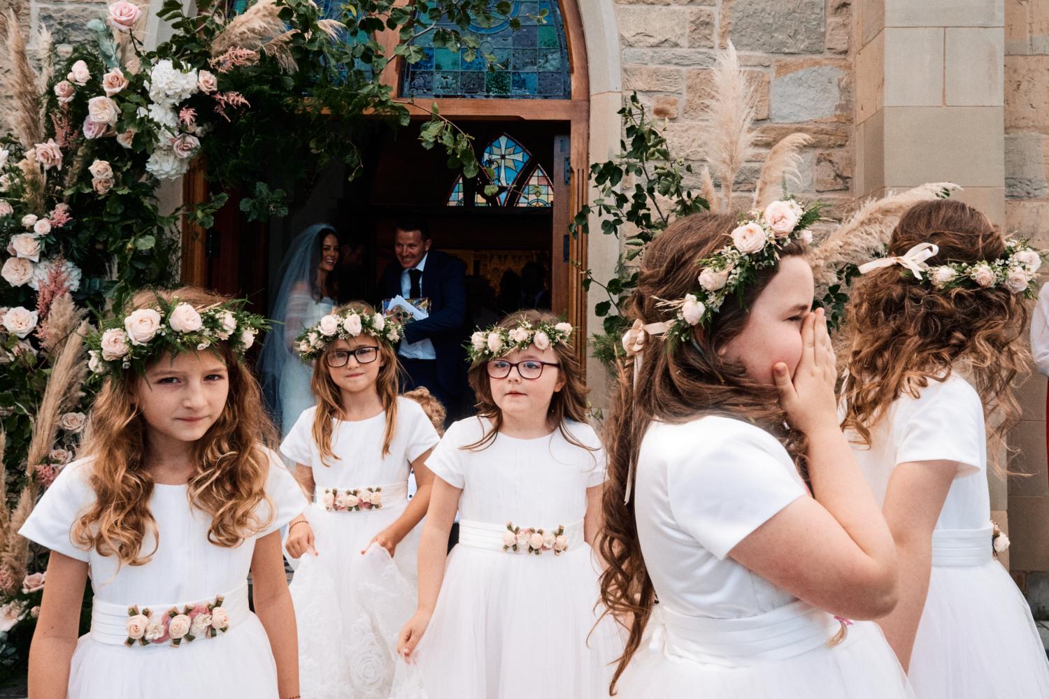 Five flower girls wearing floral head pieces
