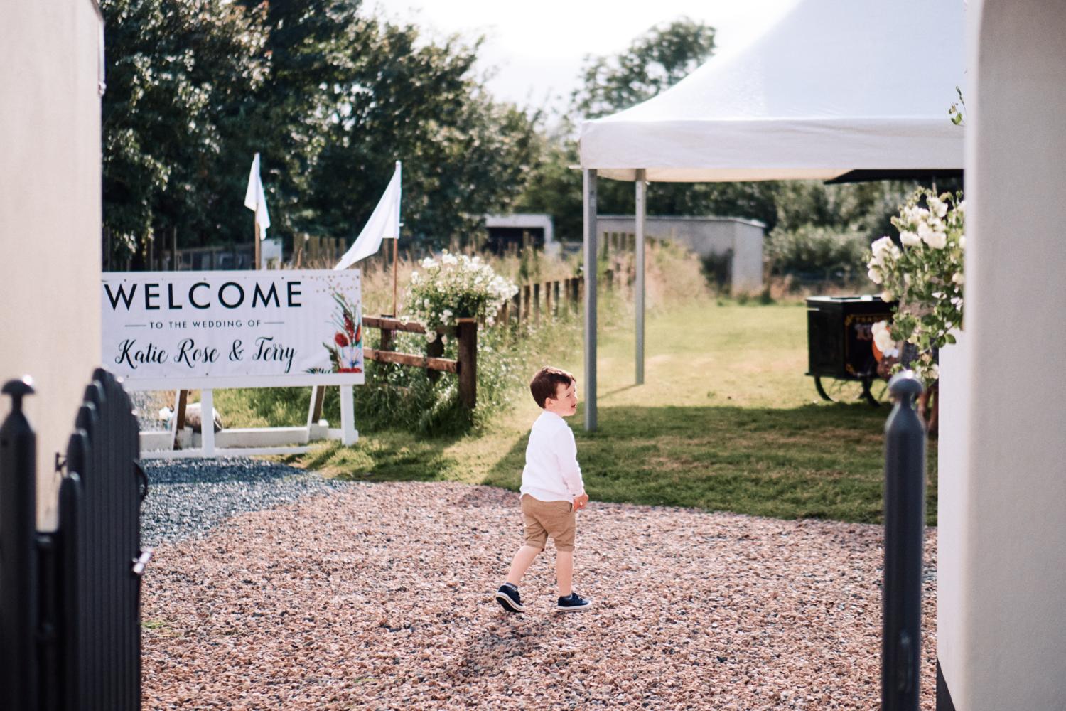 A child explores the grounds of a garden wedding reception