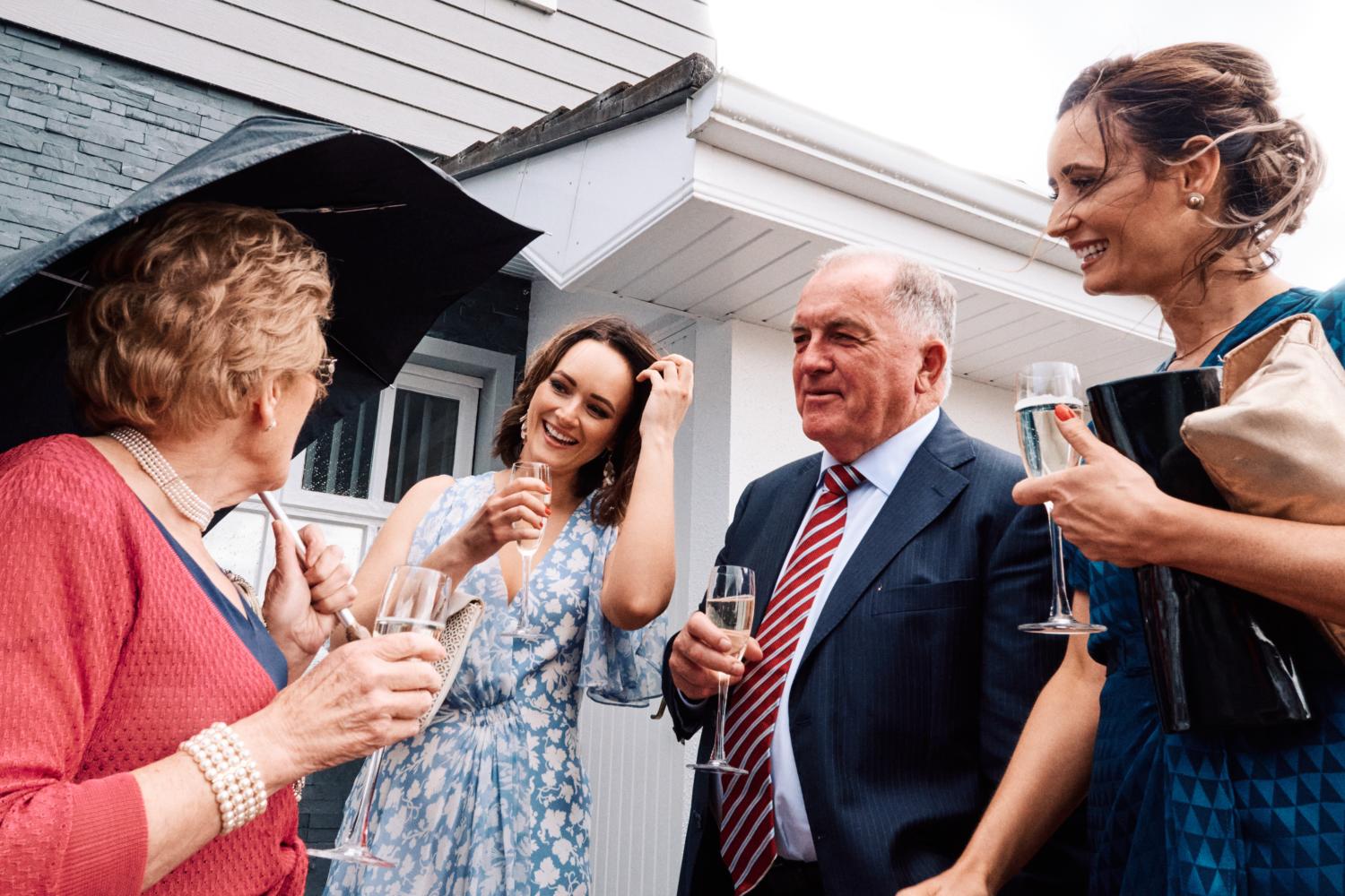 Wedding guests talk and drink champagne