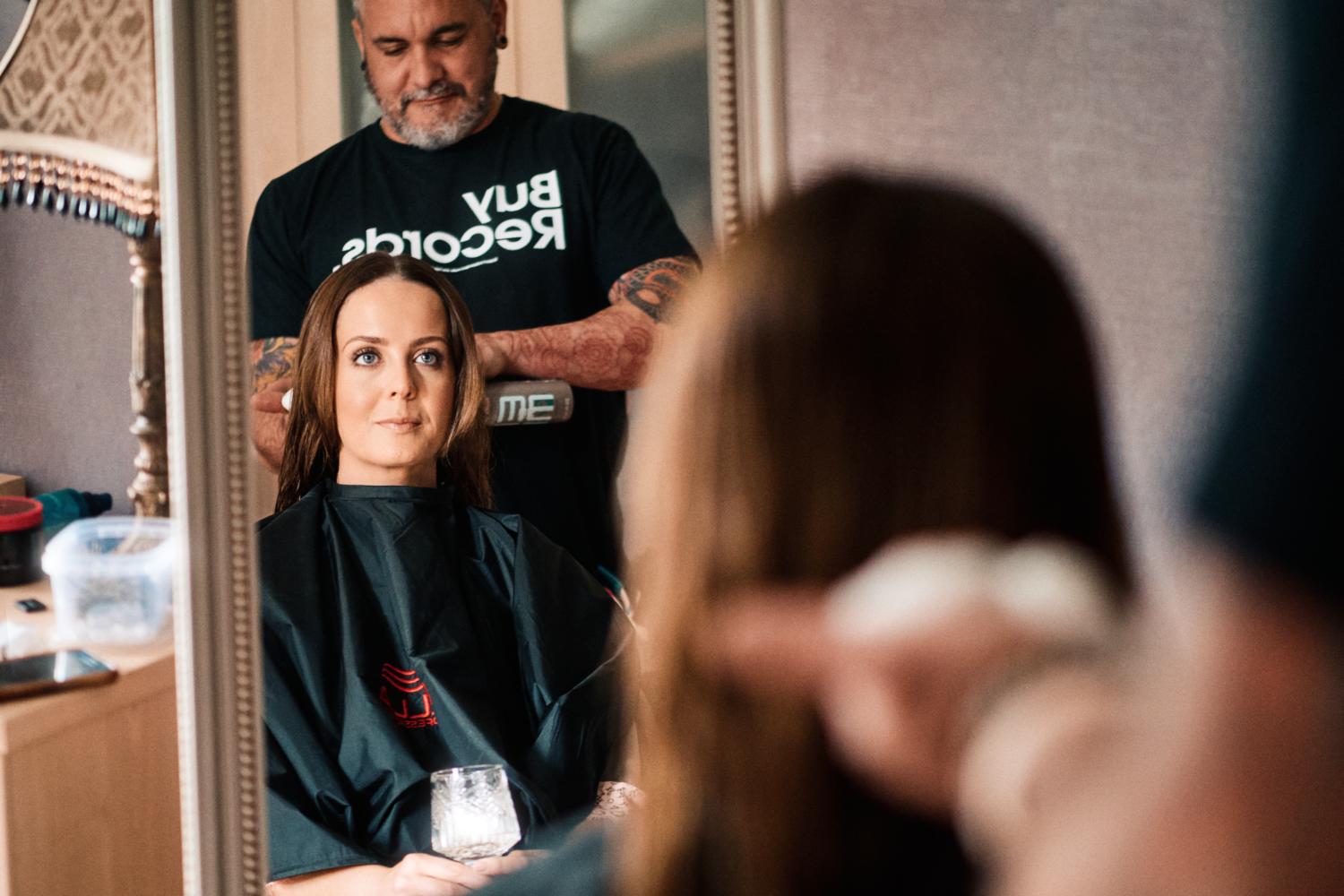 A hairdresser works with a bride on a wedding morning