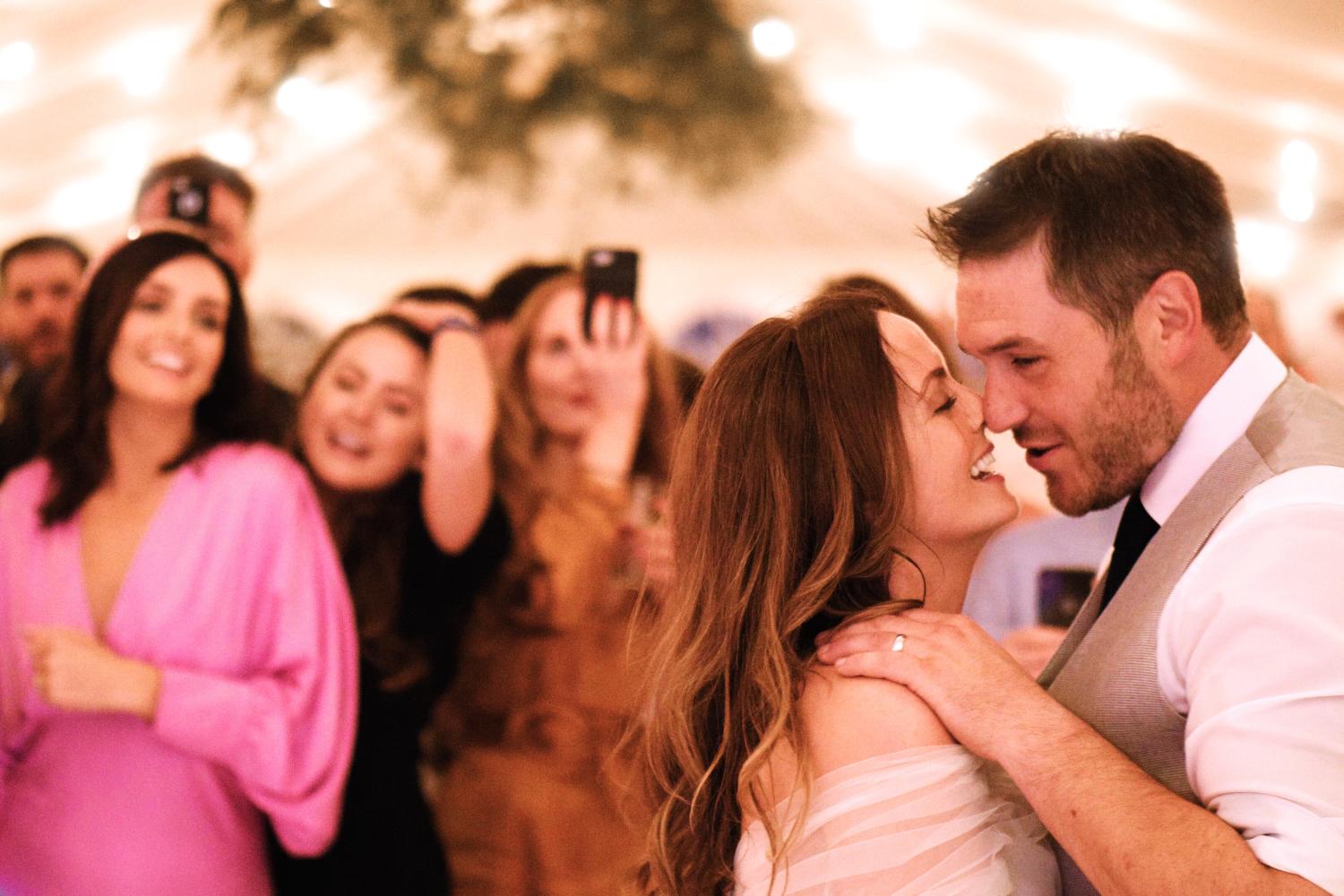 Bride and groom dancing in a marquee