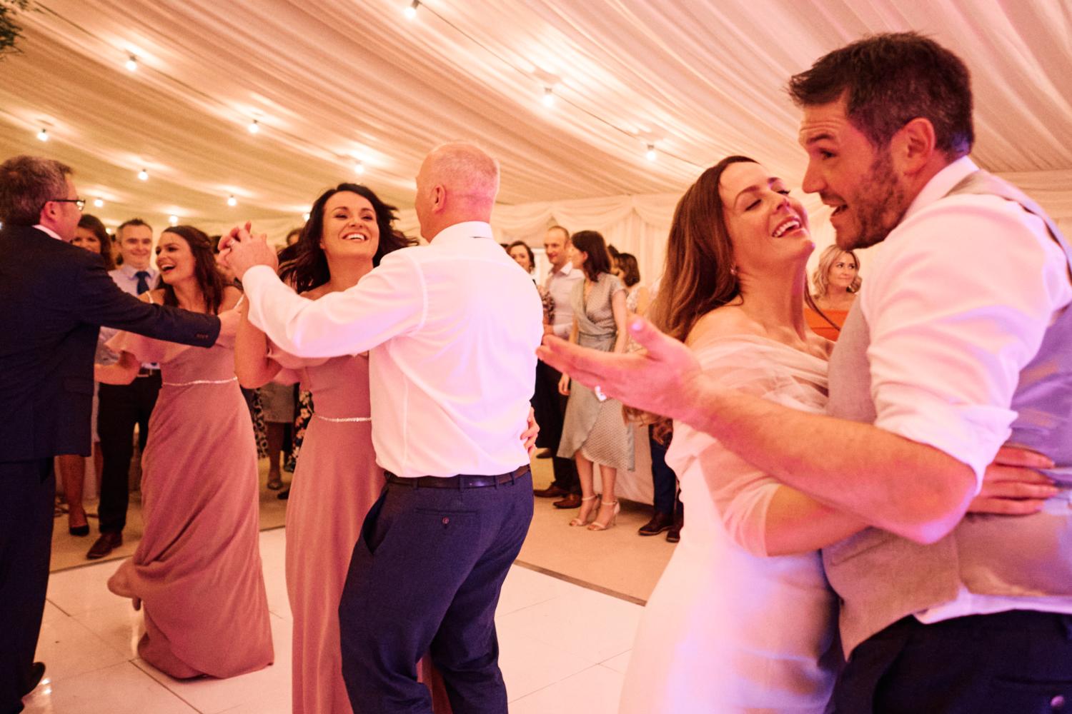 Couples dancing in a marquee at a wedding