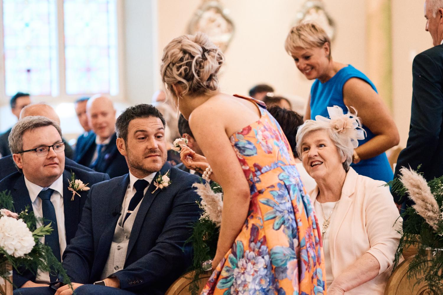 A groom receives a flower before a wedding ceremony in Dungannon