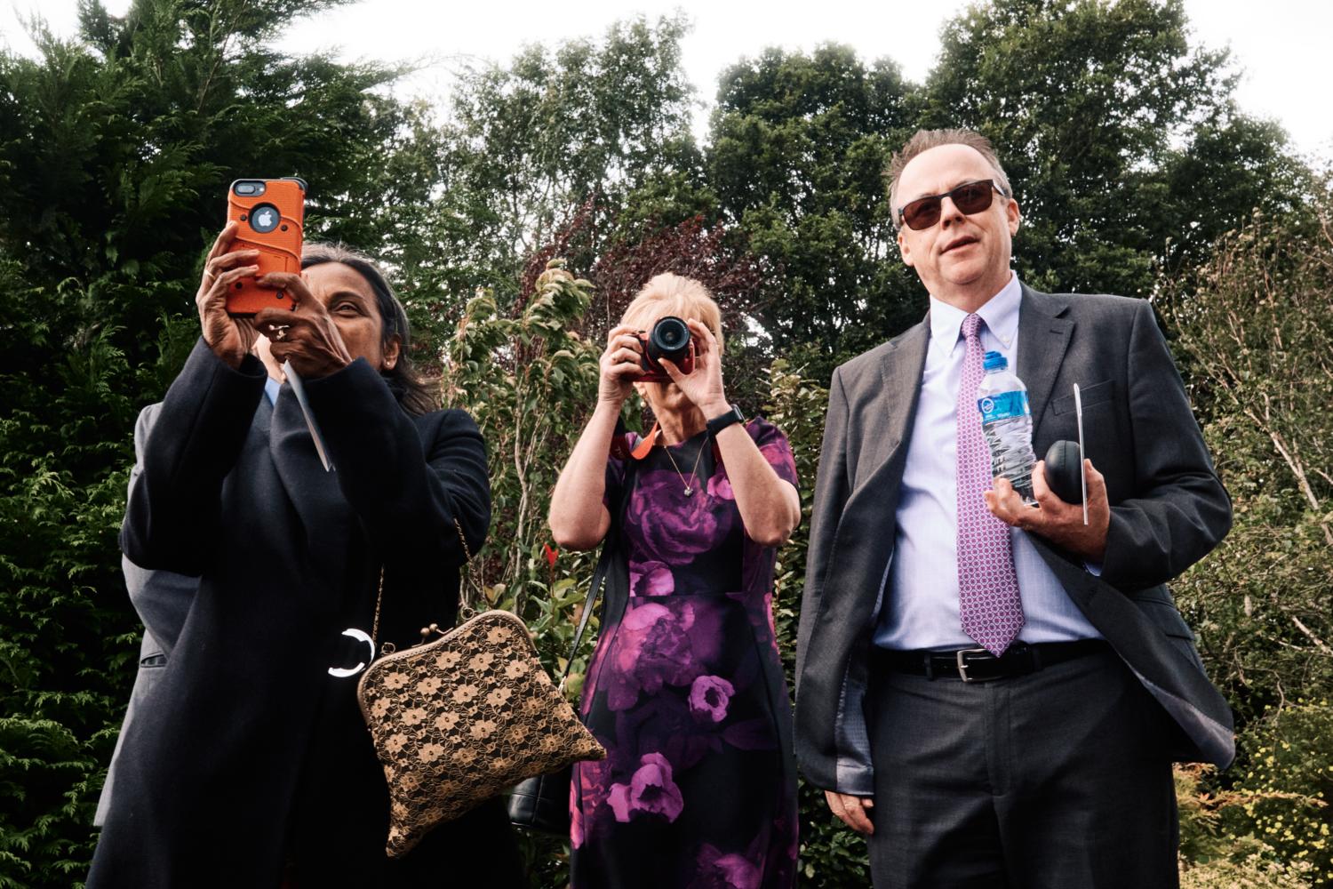 Three photographers at a wedding