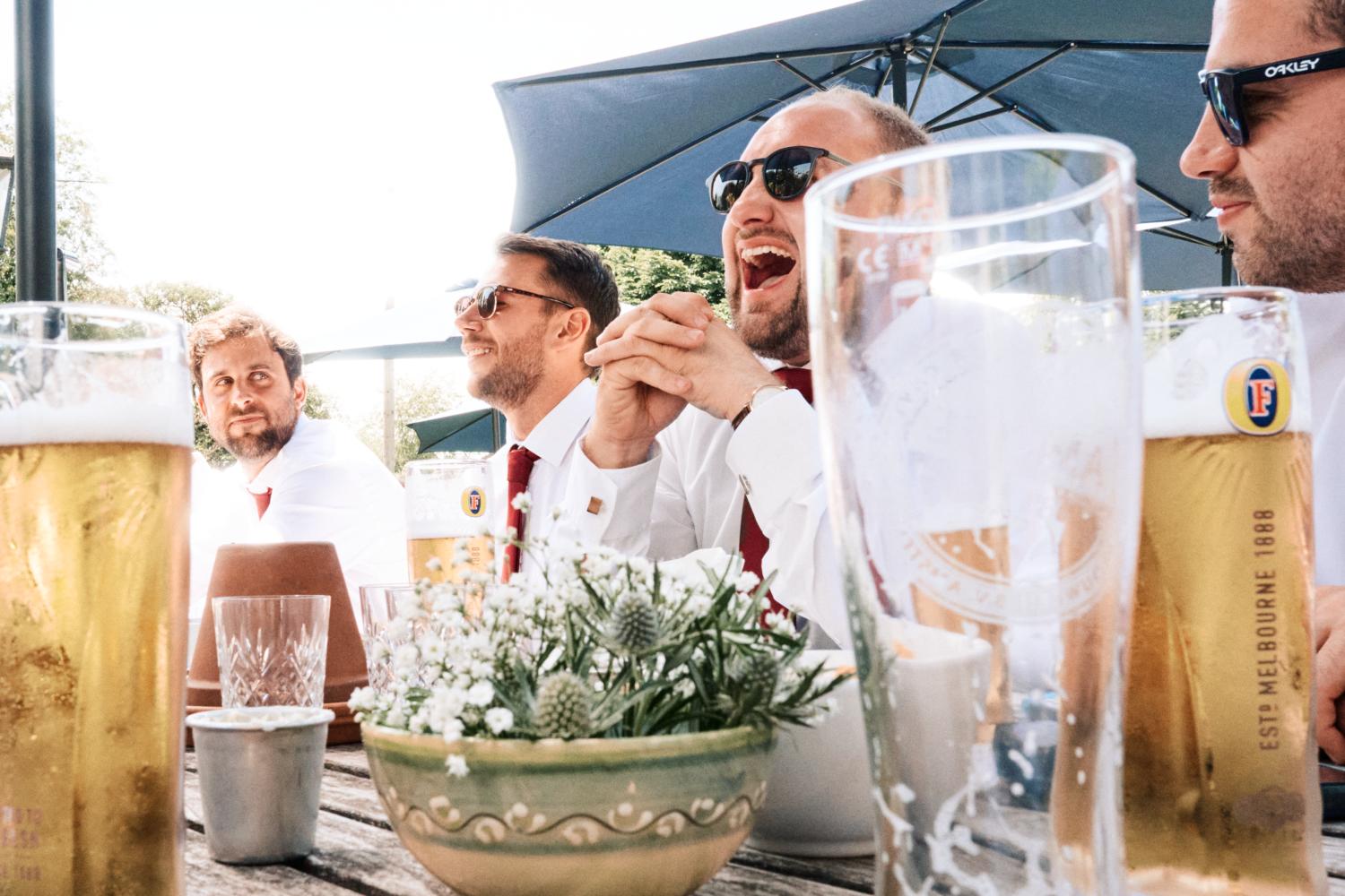 Groomsmen laughing and drinking beer