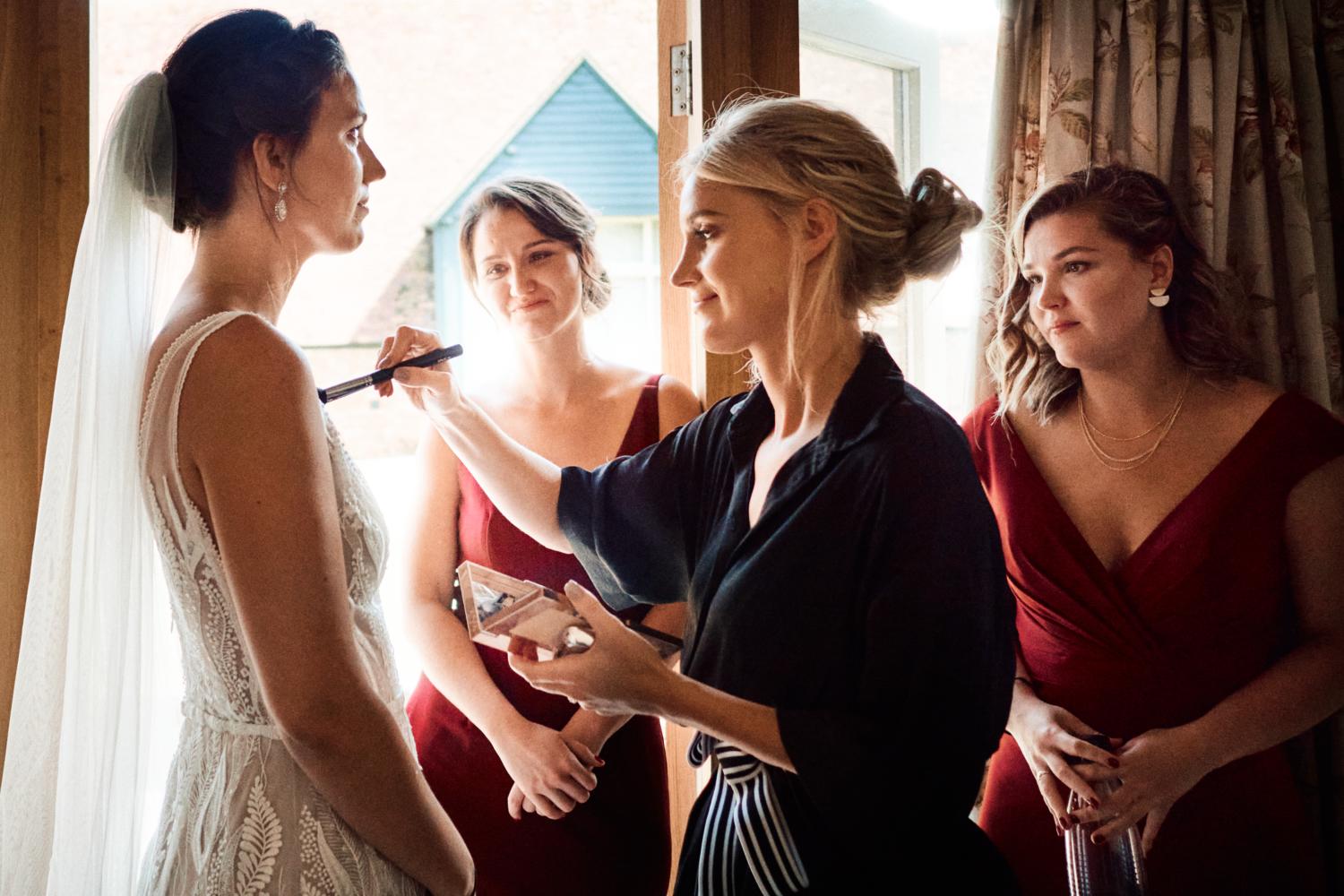 A sister looks affectionately at the bride