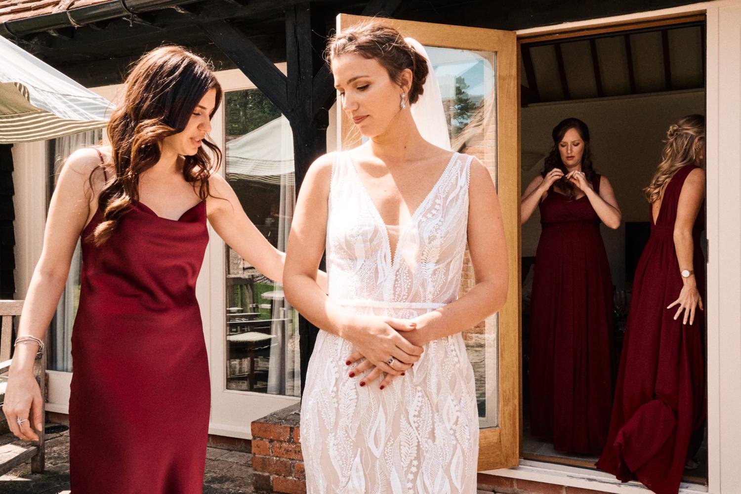 A bride walks outside in her dress