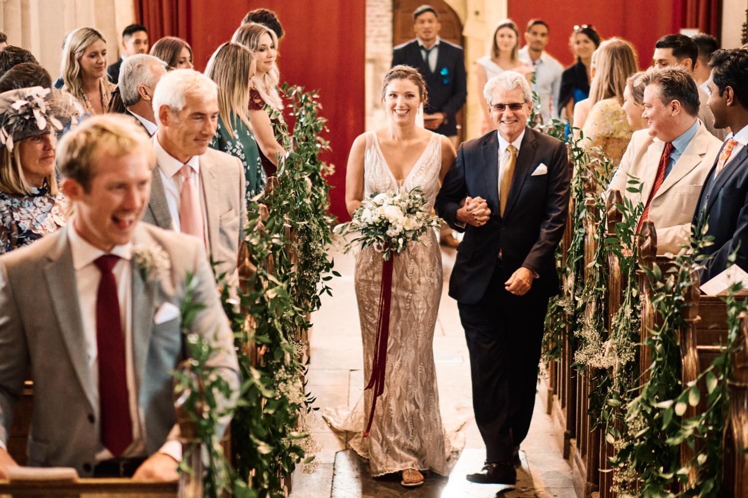 Bride walks up the aisle at Ewelme church