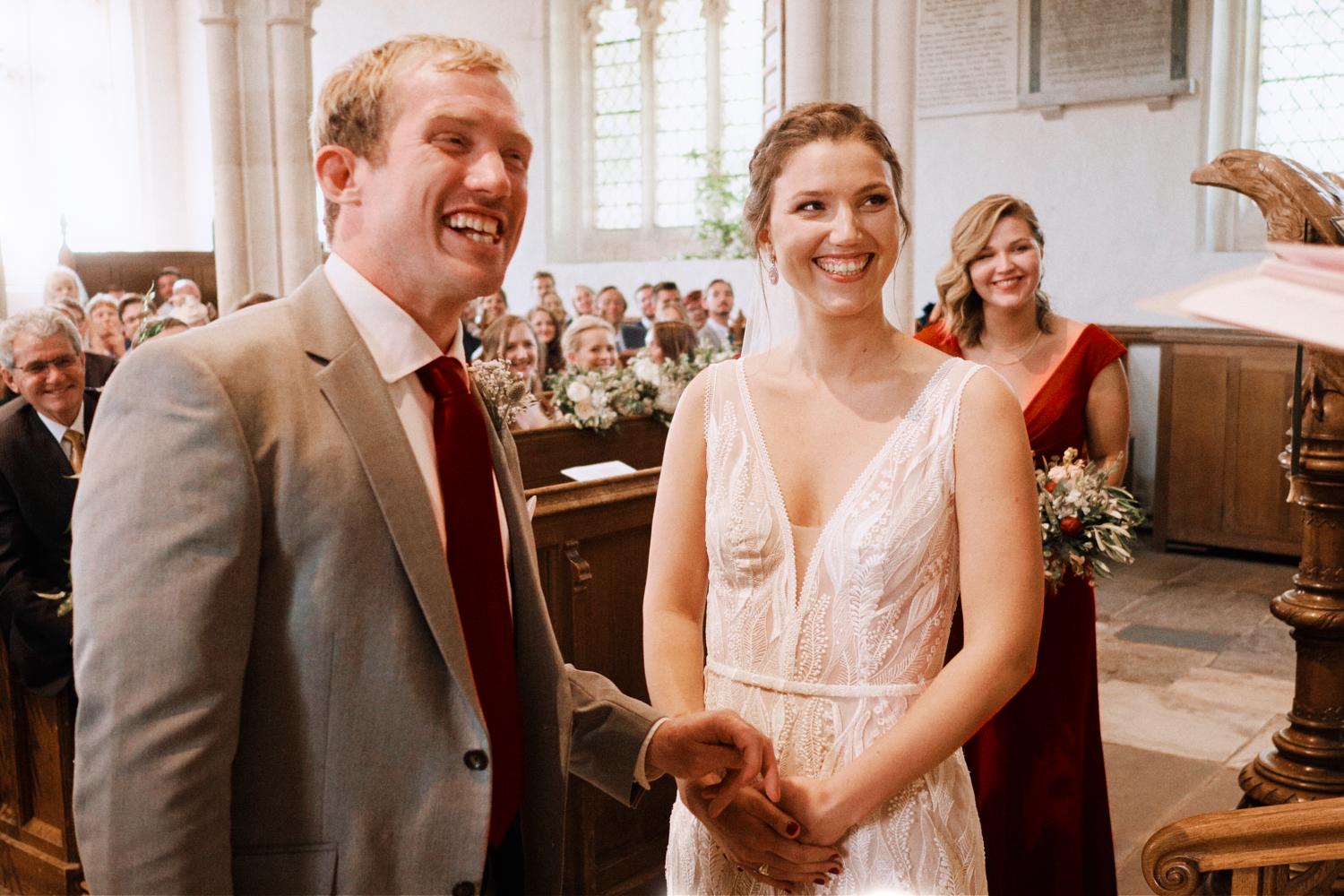 Bride and groom laugh during vows