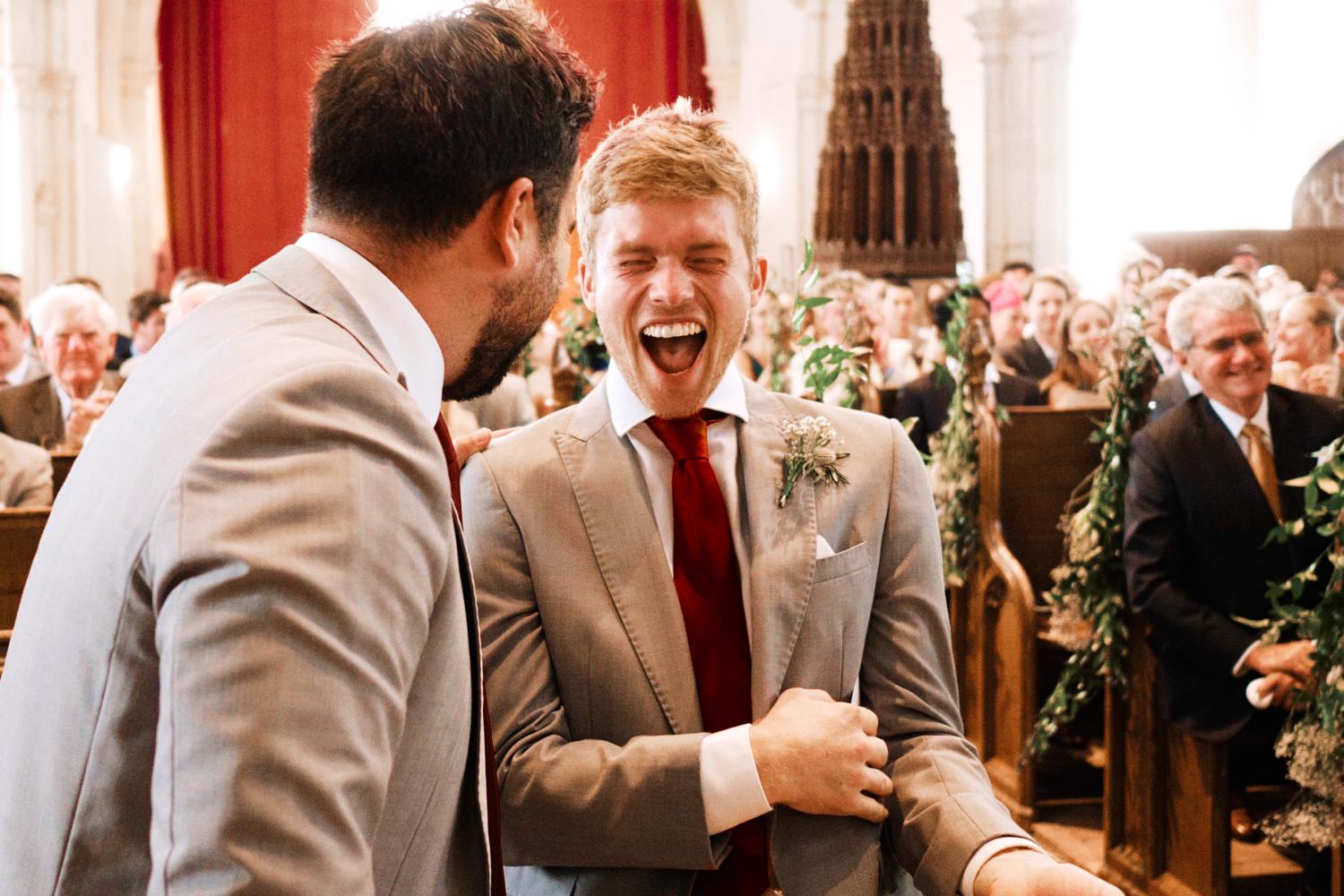 Laughing groomsmen during Ewelme wedding