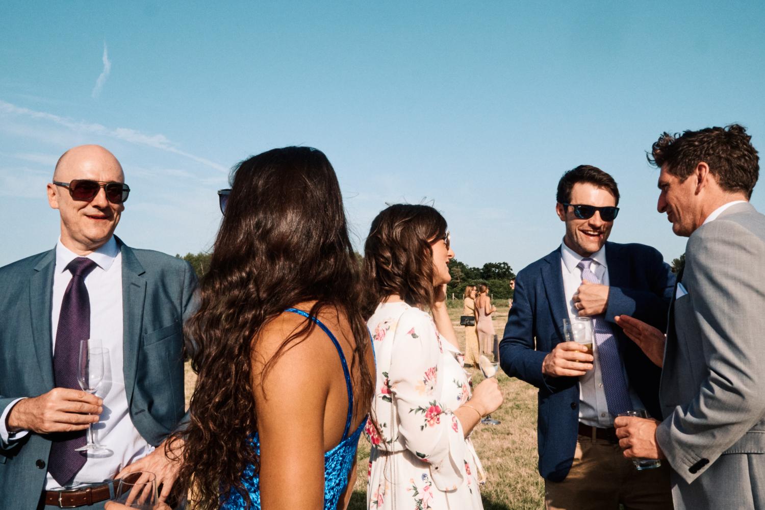 Wedding guests relaxing in a field
