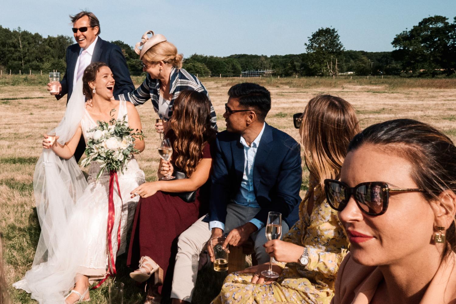 Bride and guests in a field