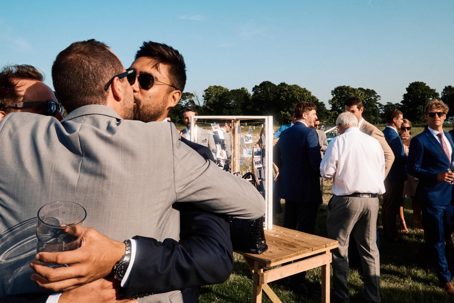 Guests kissing at Oxfordshire wedding