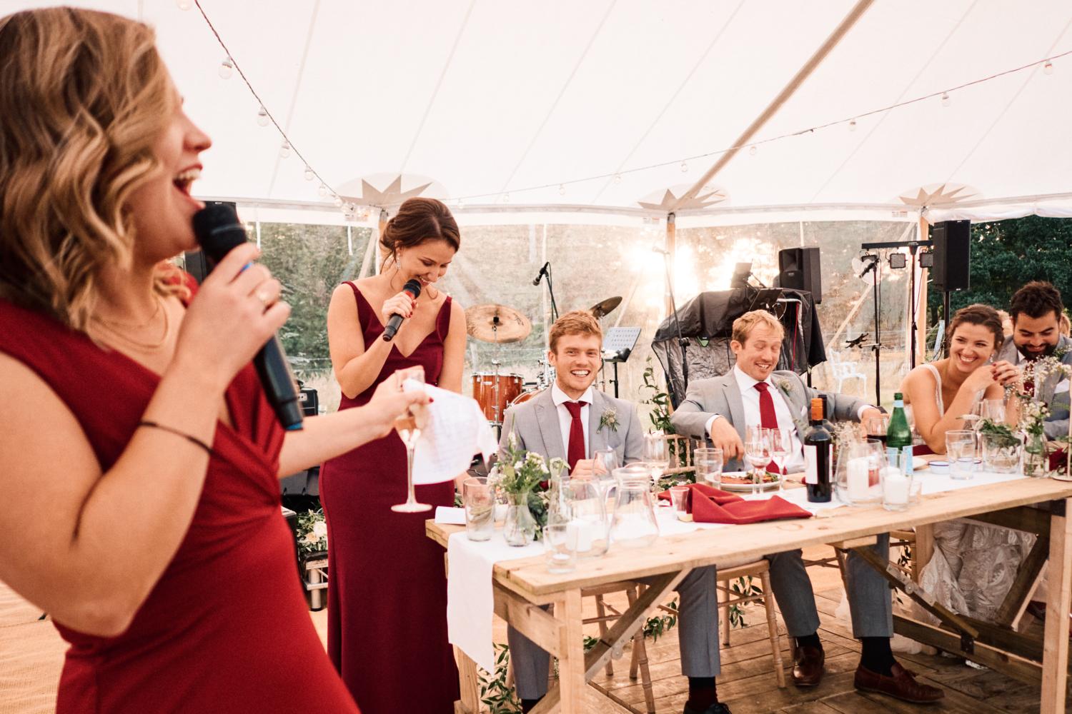 Sister of bride performs speeches in a marquee