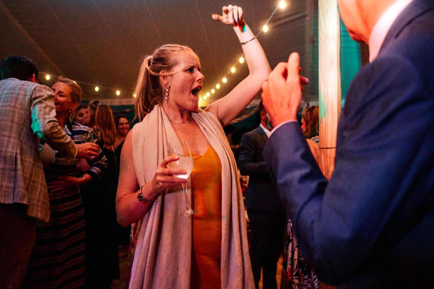 A woman gestures with her hand on the dancefloor