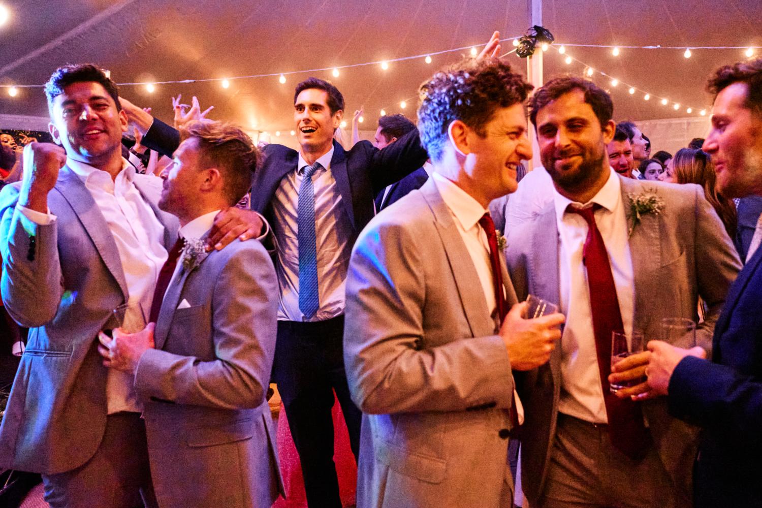 Groomsmen celebrate on dancefloor