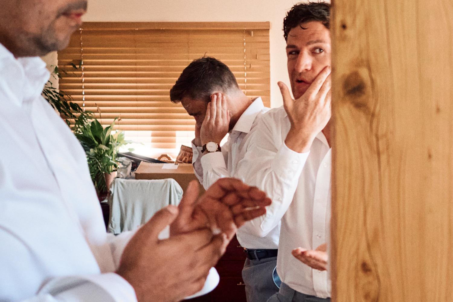 Groomsmen apply after shave on wedding morning