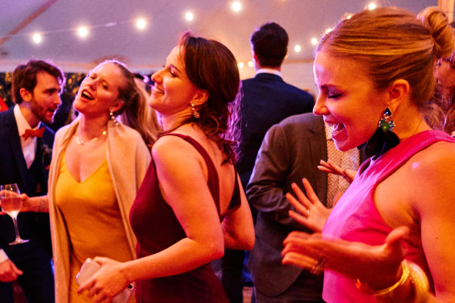 Expressive women dance on the dancefloor